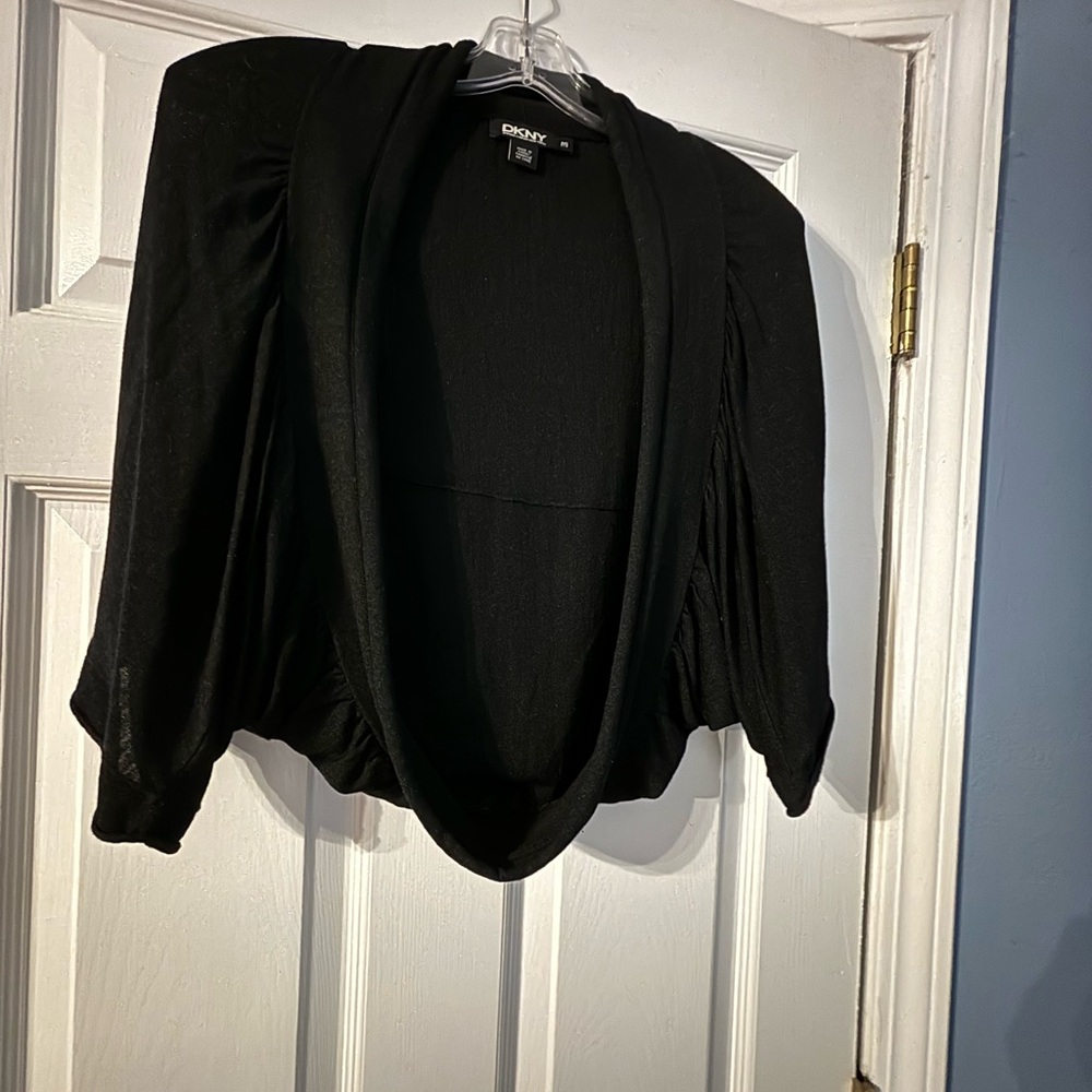 DKNY  Black Shrug Has a rounded hem all the way around it and short neck collar